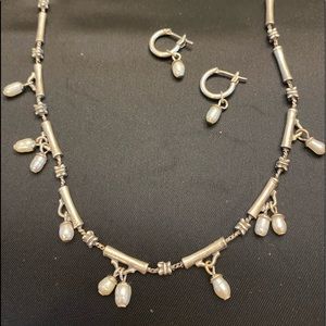 Silver necklace and earrings set with seed pearls.